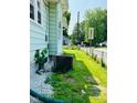 Side yard featuring a lawn area, utilities, and gravel landscaping at 547 N Livingston Ave, Indianapolis, IN 46222