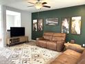 Spacious living room featuring modern decor, a neutral rug, and a wall-mounted television at 5702 Deer Valley Ct, Columbus, IN 47201