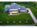 Expansive property with a manicured lawn, swimming pool and charming architectural details at 5946 Stafford Way, Indianapolis, IN 46228