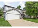 Charming two-story home with a two-car garage, tidy landscaping, and inviting front porch at 5966 Draycott Dr, Indianapolis, IN 46236