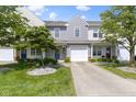 Charming townhouse with attached garage, landscaped front yard, and a tree in a bed of rocks at 603 Daviess Dr, Westfield, IN 46074