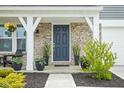 Charming front porch featuring decorative columns, planters, and a welcoming entrance at 6305 N Woodhaven Dr, McCordsville, IN 46055