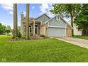Charming brick and siding home with a well-manicured lawn and a two-car garage at 6518 Springview Dr, Avon, IN 46123