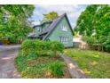Charming home exterior with lush greenery, complemented by a well-maintained lawn and quaint walkway at 715 Kessler Blvd E Dr, Indianapolis, IN 46220