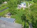 Sprawling property featuring a large lawn, multiple outbuildings, and a charming gazebo at 7850 S Mooresville Rd, Indianapolis, IN 46113