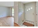 Inviting entryway with hardwood floors, tiled accents, and a coat closet for added convenience at 8071 Chiltern Dr, Indianapolis, IN 46268