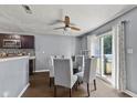 Dining room with stylish table, a ceiling fan, and sliding door access to the backyard at 9125 Timpani Way, Indianapolis, IN 46231