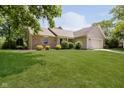 Inviting home showcasing lush green lawn, mature trees, and a blend of siding and brick exterior accents at 9363 Hadway Dr, Indianapolis, IN 46256