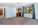 Bright, airy living room featuring freshly painted walls, neutral carpet, and natural light from the window at 9458 Dawn Dr, Brownsburg, IN 46112