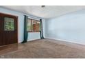 Bright, airy living room featuring freshly painted walls, neutral carpet, and natural light from the window at 9458 Dawn Dr, Brownsburg, IN 46112