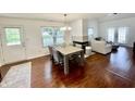 Hardwood floors highlight the dining area, complete with table and chairs and an adjacent open-concept living room at 9664 Legare St # 2601, Fishers, IN 46038
