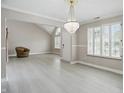 Bright, airy living room featuring neutral colors, wood-look floors, and a decorative chandelier at 10410 Trillium Ct, Noblesville, IN 46060