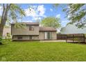 A spacious backyard with a concrete patio and a well-maintained lawn and mature trees at 11114 Wismar Dr, Indianapolis, IN 46235