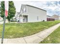 Side view of a two-story house with a well-manicured lawn at 11303 Cuyahoga Dr, Indianapolis, IN 46235