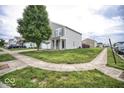 Street view of a two-story house with well-kept lawn and sidewalk at 11303 Cuyahoga Dr, Indianapolis, IN 46235