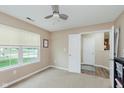 Bedroom features large window, neutral walls, carpet flooring, and closet, creating a cozy atmosphere at 11521 Short Iron Ln, Indianapolis, IN 46235