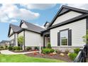 Beautifully landscaped modern home with elegant architectural features and a walkway at 12594 Pasco St, Fishers, IN 46038