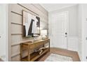 Inviting foyer featuring stylish console table, modern art, and wood floors at 12594 Pasco St, Fishers, IN 46038