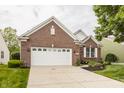 Beautiful single-Gathering brick home featuring a two-car garage, tidy landscaping, and green lawn at 13091 Duval Dr, Fishers, IN 46037