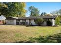 Well-maintained home with a two-car garage and a lush green lawn at 1325 Alimingo Dr, Indianapolis, IN 46260