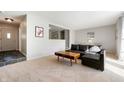 Inviting living room featuring neutral tones, a stylish black sectional, and natural light at 1325 Alimingo Dr, Indianapolis, IN 46260