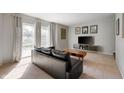 Bright living room with large windows, a modern console, and comfortable seating at 1325 Alimingo Dr, Indianapolis, IN 46260