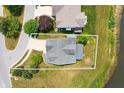Aerial view of a house showcasing its backyard, proximity to a pond, and surrounding greenery at 1412 Huntzinger Blvd, Pendleton, IN 46064