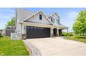 Two-story home with a well-maintained lawn, complemented by an attached garage and landscaped front yard at 1412 Huntzinger Blvd, Pendleton, IN 46064