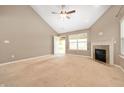 Bright living room with a fireplace, neutral walls, and ample natural light coming from the backyard at 1412 Huntzinger Blvd, Pendleton, IN 46064