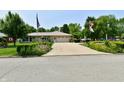 Attractive home with a well-maintained lawn, colorful flowerbeds, and a paved driveway at 1910 Ivy Dr, Anderson, IN 46011