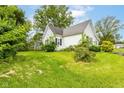 Spacious backyard showcasing the home's exterior and ample green space at 2009 S L St, Elwood, IN 46036