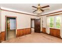 Living room with wood trim, ceiling fan, and natural light from a window at 2009 S L St, Elwood, IN 46036