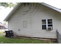 Exterior view of home with vinyl siding and trash bins at 2232 Fairview St, Anderson, IN 46016