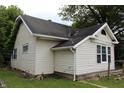 Exterior view of home with vinyl siding, black roof and manicured lawn at 2232 Fairview St, Anderson, IN 46016