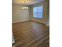 Well-lit dining room with modern chandelier and wood-look floors at 2540 Lullwater Ln, Indianapolis, IN 46229
