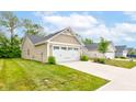 The property boasts a manicured lawn and an attached two-car garage at 2747 Stonebridge Dr, Lebanon, IN 46052
