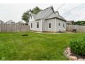Spacious backyard with a well-maintained lawn and privacy fence, perfect for outdoor enjoyment at 305 N Warman Ave, Indianapolis, IN 46222