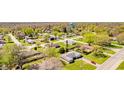A wide aerial view of a residential neighborhood with tree-lined streets and well-maintained homes at 3215 E 10Th St, Anderson, IN 46012