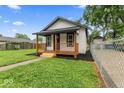 Quaint house with a covered porch, perfect for enjoying the outdoors at 3453 W 12Th St, Indianapolis, IN 46222