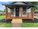 Close-up of the home's covered front porch, showcasing its wooden railings and steps at 3453 W 12Th St, Indianapolis, IN 46222