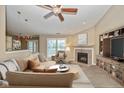 Cozy living room features a fireplace, ceiling fan, and ample natural light at 3779 Crest Point Dr, Westfield, IN 46062