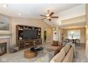 Bright living room featuring a fireplace, entertainment center, and view into the dining area at 3779 Crest Point Dr, Westfield, IN 46062
