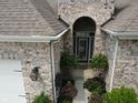 Arched entryway welcomes you with lush ferns and plantings to the brick home's front door at 4232 Parliament Way, Avon, IN 46123