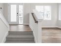 Bright entryway features carpeted stairs, wood flooring, and natural light at 449 Shade St, Carmel, IN 46290