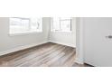 A bright, empty room with light walls, wood floors, and multiple windows at 449 Shade St, Carmel, IN 46290