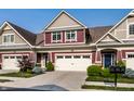Inviting townhome featuring a two-car garage, stylish front door, and well-kept landscaping at 478 Firefly Ln, Carmel, IN 46032
