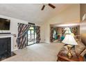 Cozy living room featuring a fireplace, plush carpet, and ample natural light from sliding glass doors at 4965 Hawthorne Way, Avon, IN 46123