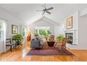 Bright living room with vaulted ceilings, fireplace, and hardwood floors at 5108 Riverview Dr, Indianapolis, IN 46208