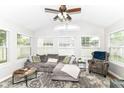 Sunlit living room with large windows, neutral decor, comfortable seating, and a relaxing vibe at 5651 Pine Knoll Blvd, Noblesville, IN 46062