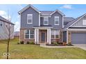 Charming two-story home with brick and siding, a manicured lawn, and a two-car garage at 5655 Lighthouse Dr, Brownsburg, IN 46112